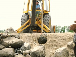 Setting boulders on hillside